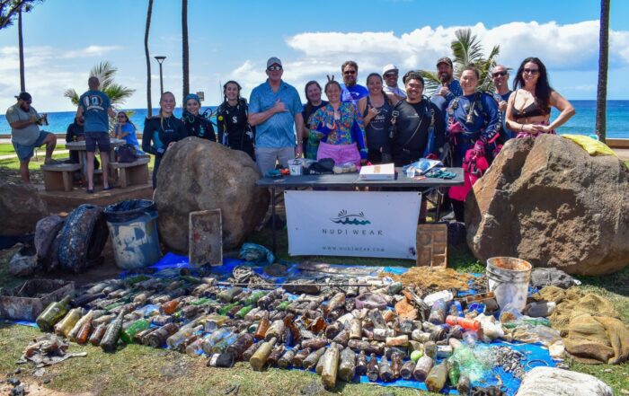 Nudi Wear volunteers with 402 pounds of trash removed from the ocean at Point Panic, a popular dive site on Oahu
