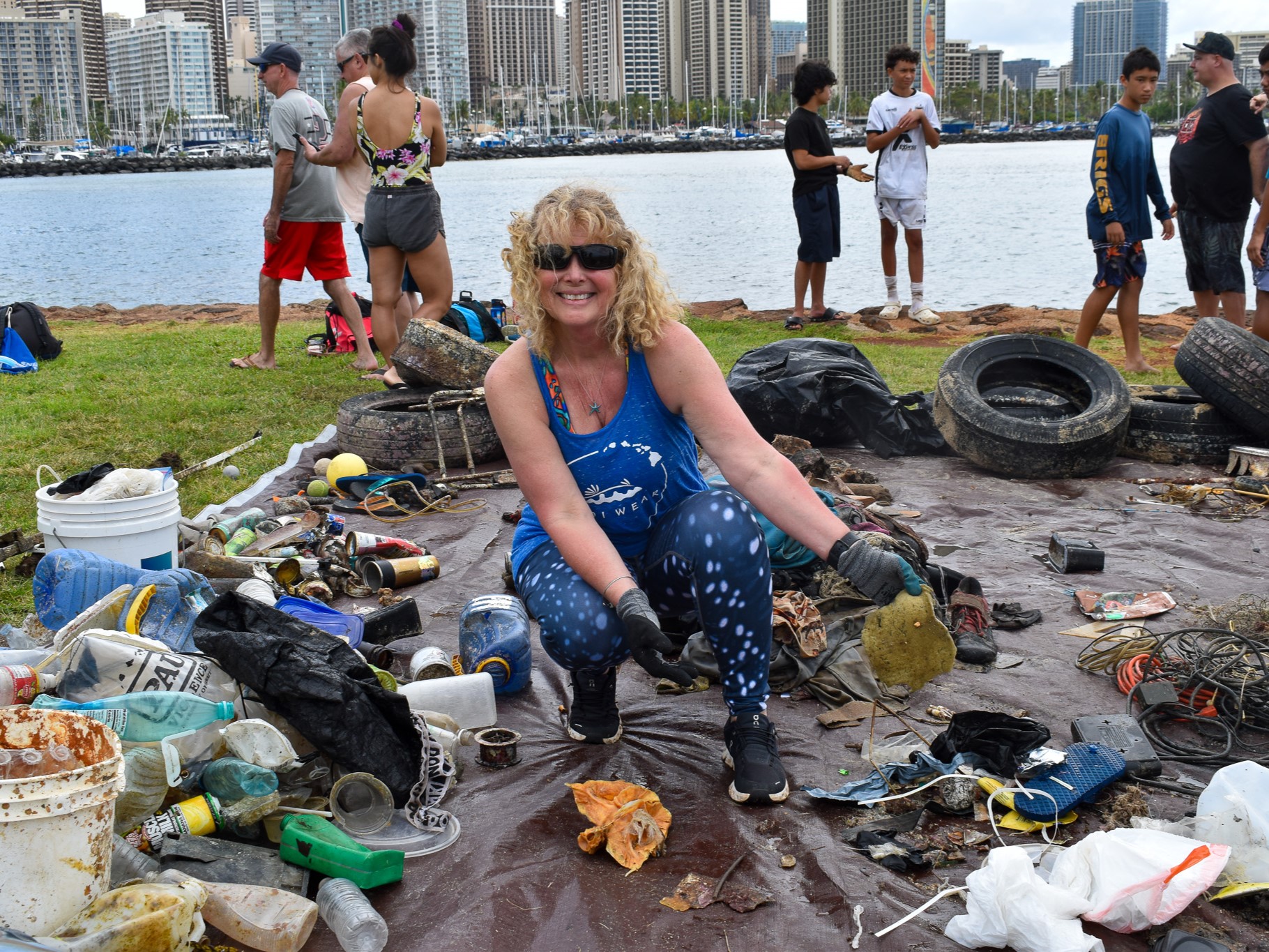 Nudi Wear volunteer sorting trash removed while diving at Magic Island