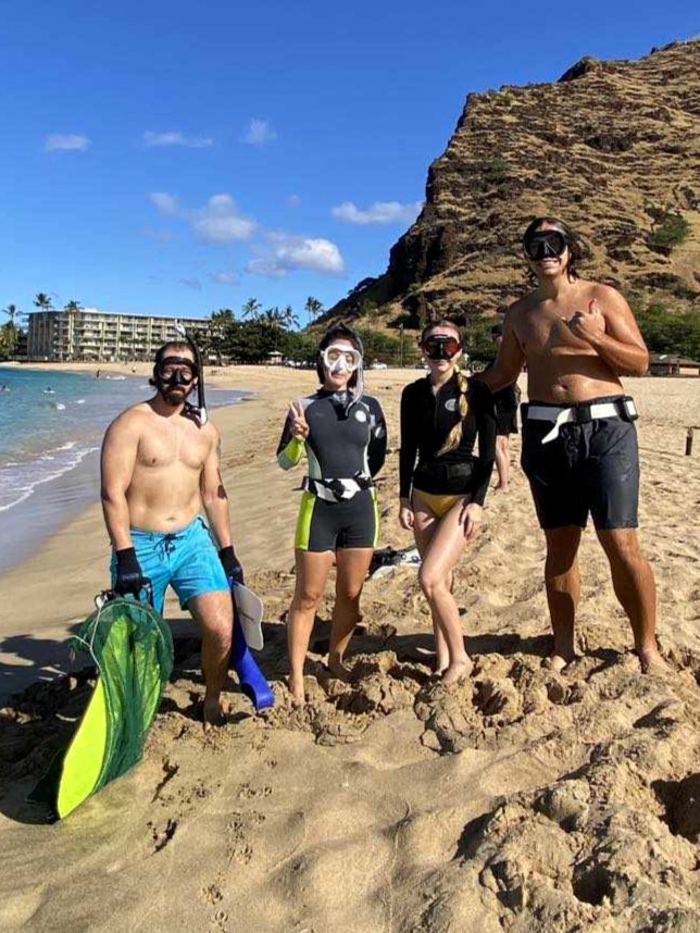 A group of freedivers gearing up at Makaha Beach Park to enter the water