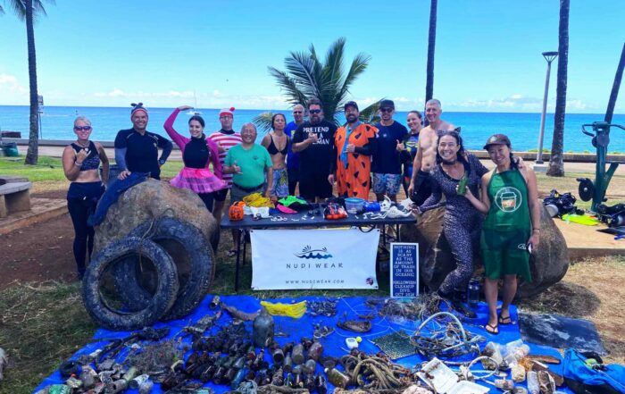 Nudi Wear volunteers with all the marine debris found during the Halloween Cleanup dive