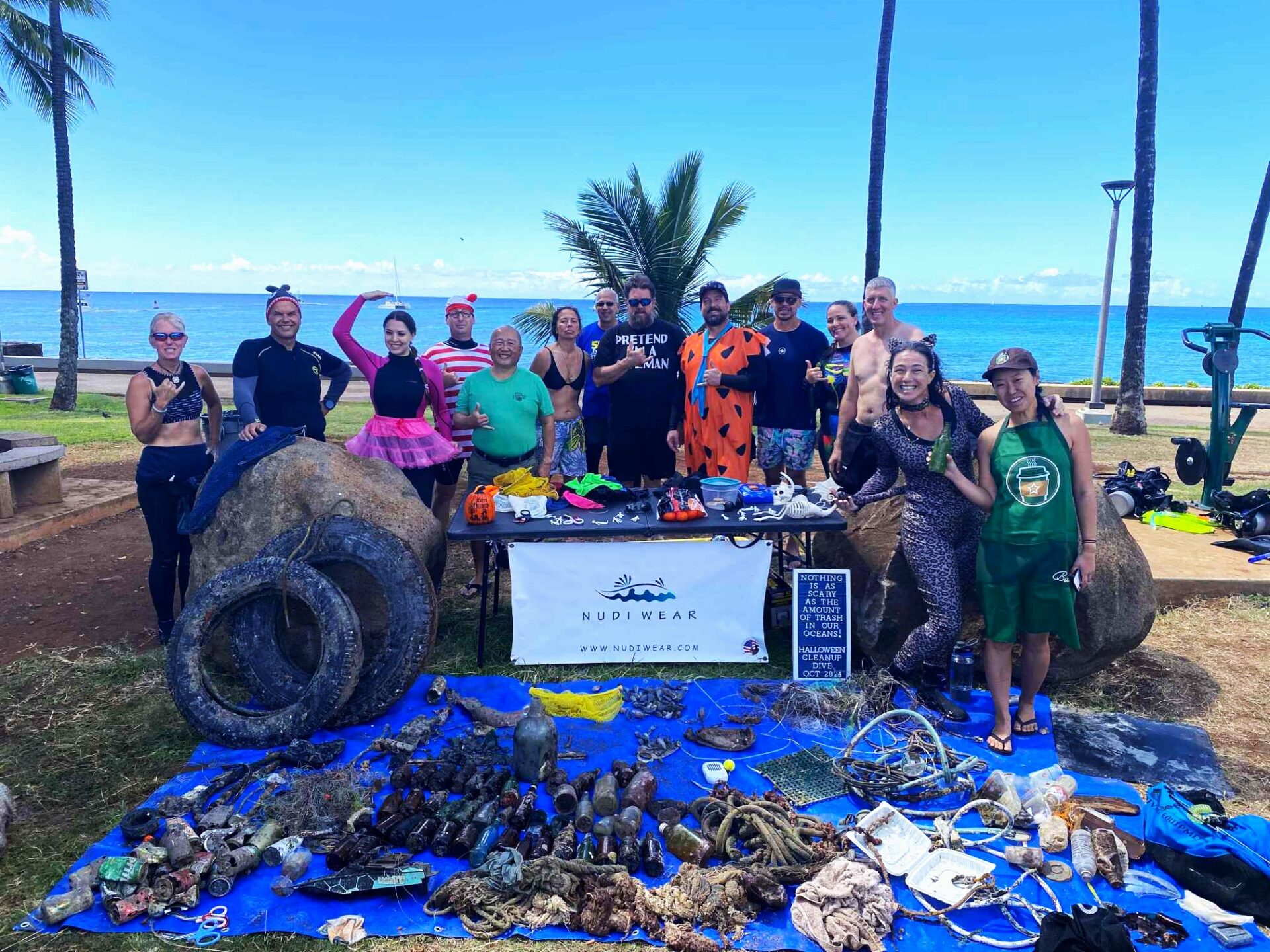 Nudi Wear volunteers with all the marine debris found during the Halloween Cleanup dive