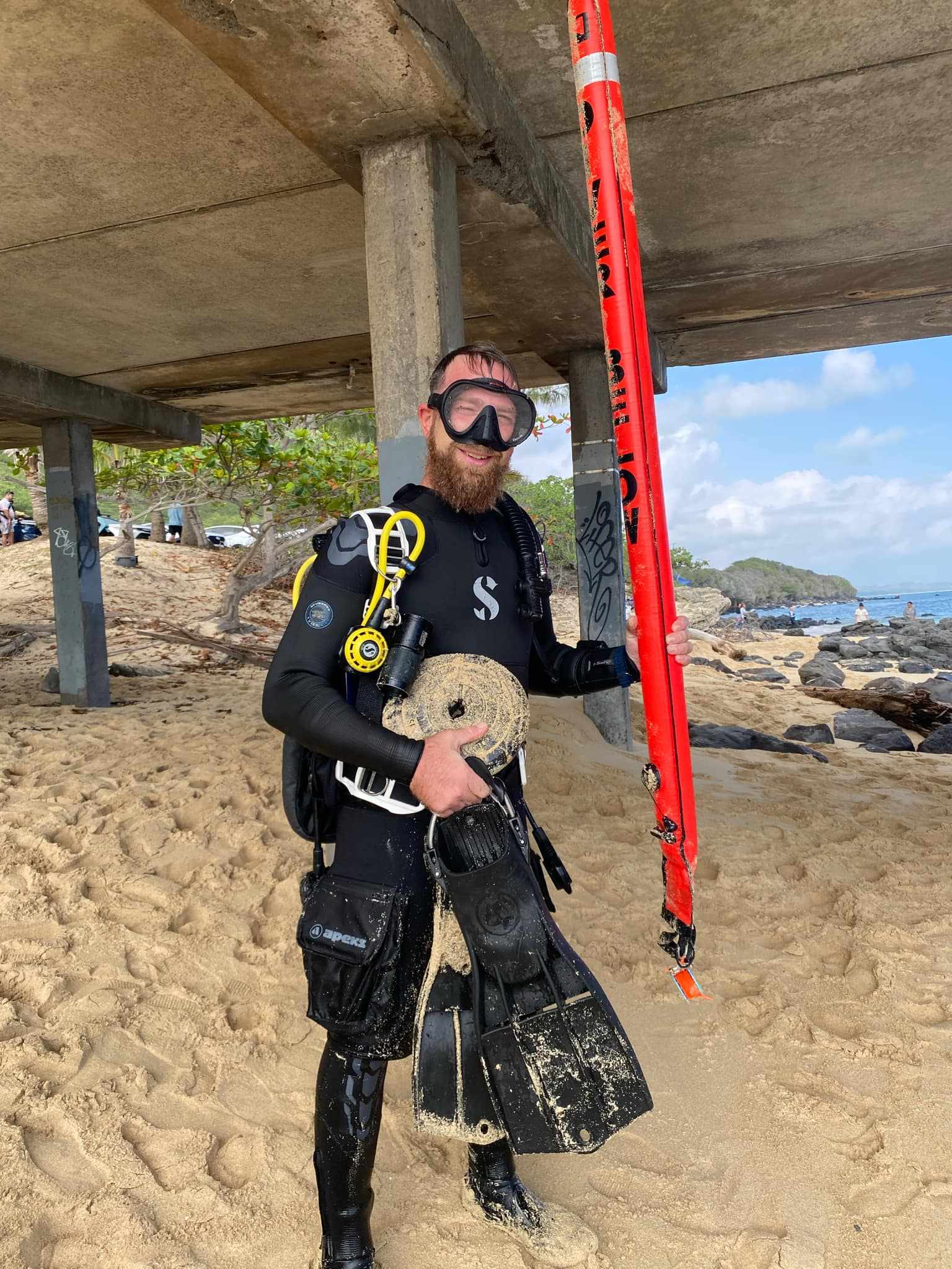 Diver with a weight he removed from the ocean