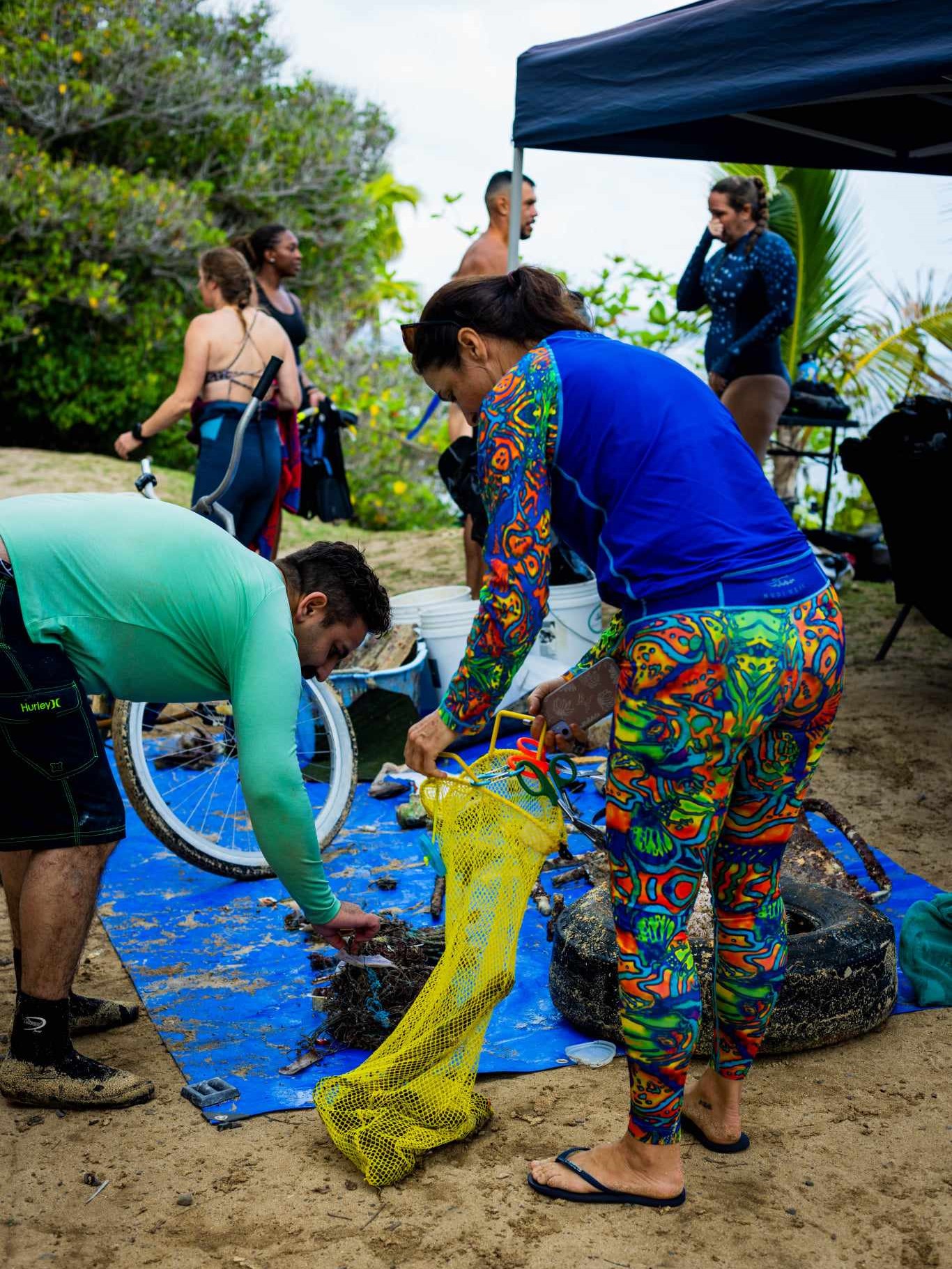 Nudi Wear volunteers sorting through marine debris removed during the pier cleanup