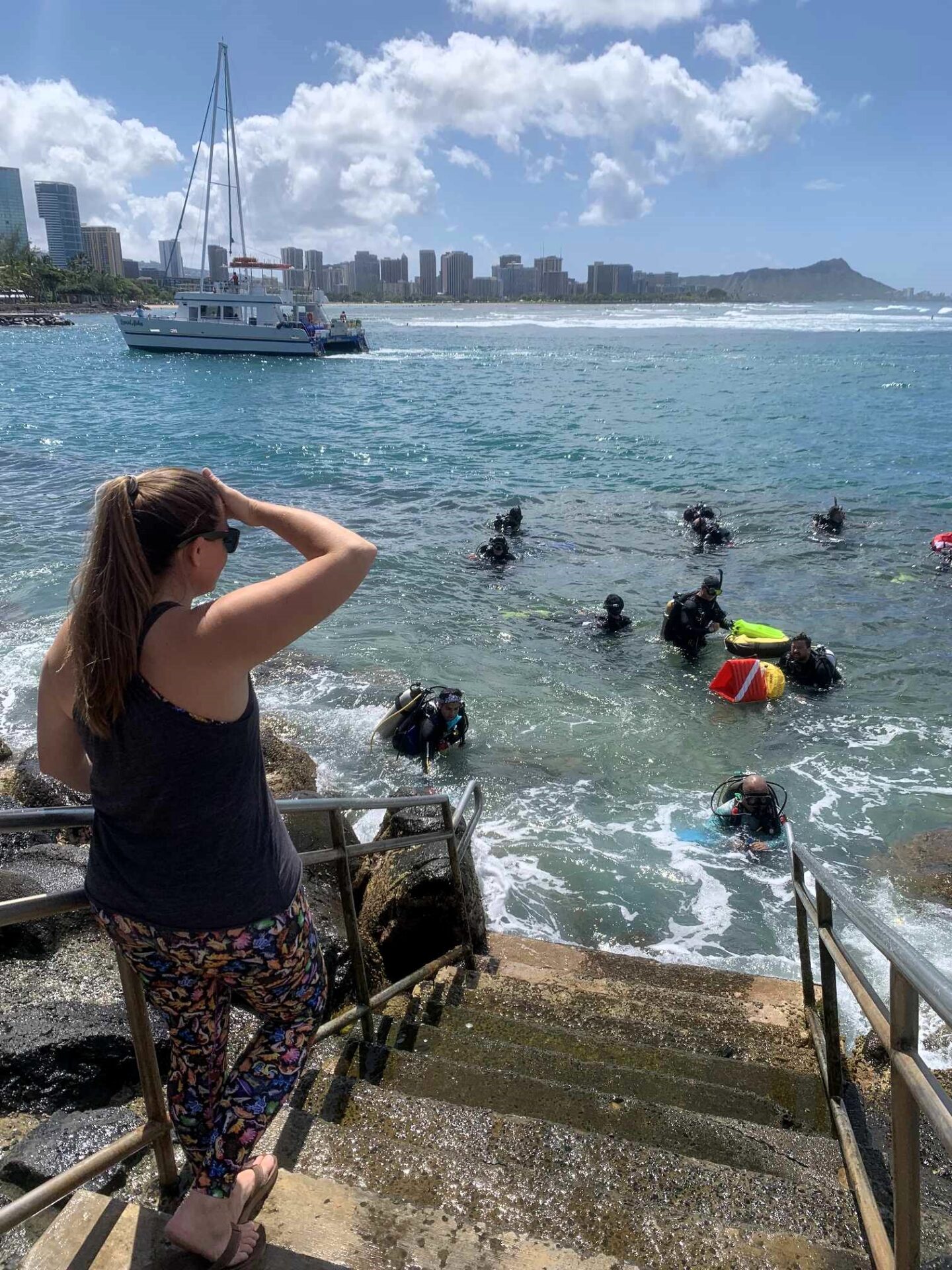 Nudi Wear volunteer dives surfacing with bags full of trash