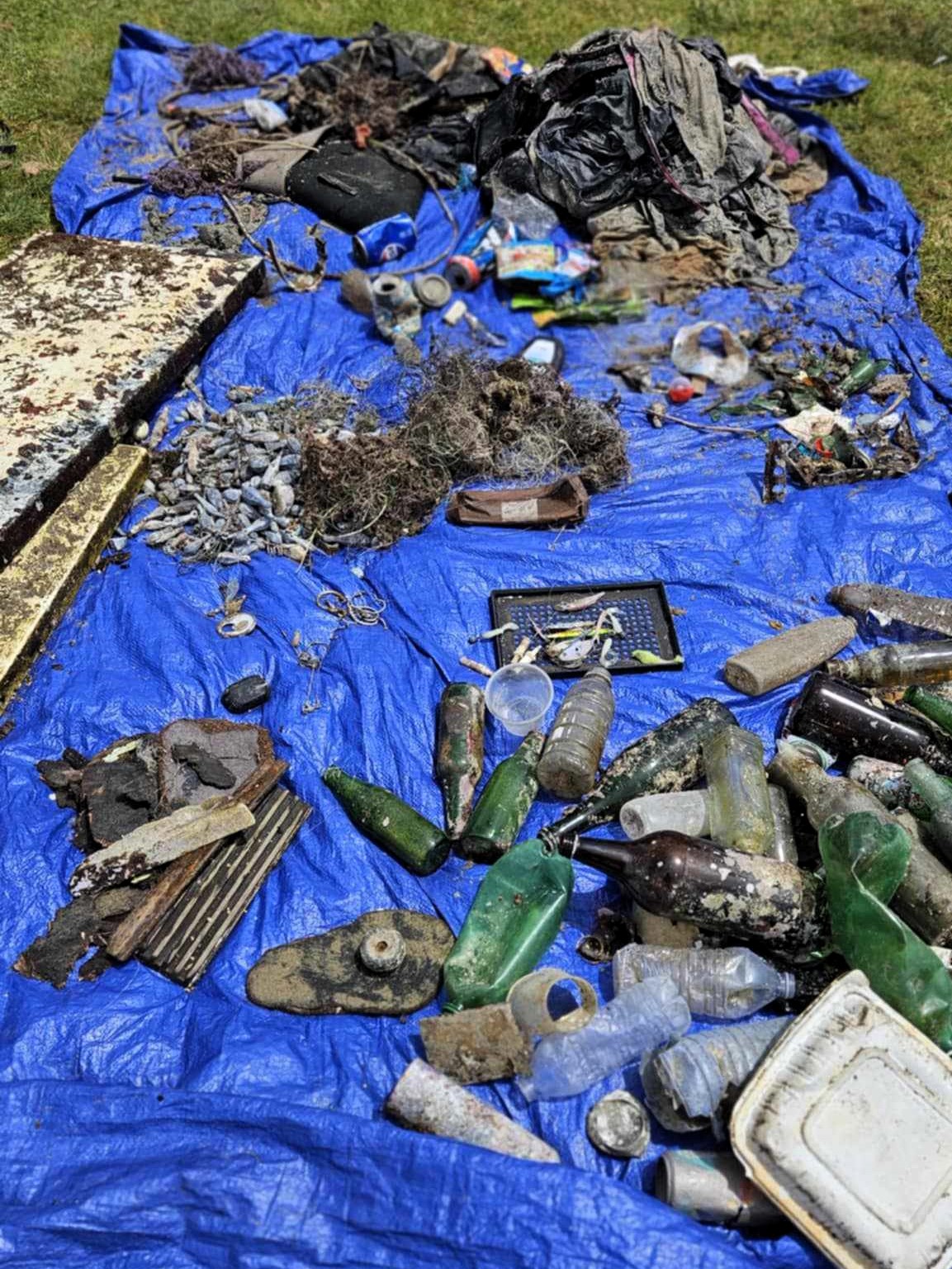 piles of trash removed from the ocean during the Dive For Earth Day cleanup
