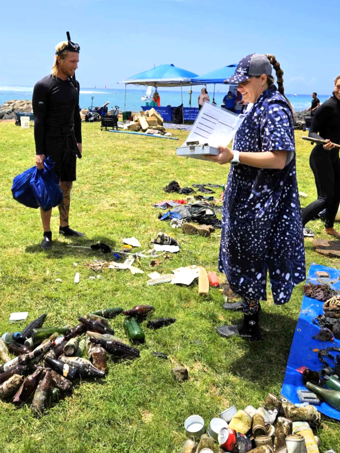 Christy, founder of Nudi Wear, documenting all of the debris pulled from the ocean for PADI Aware