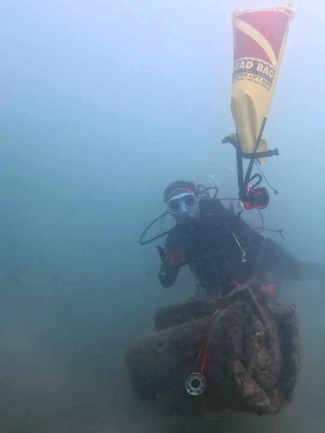 Volunteer conducting Hawaii marine debris removal with a lift bag